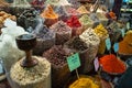 Incense burning alongside coloured spices for sale in Dubai Creek Souk, UAE.