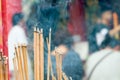 Incense joss stick burning slowly with fragrant smell smoke. People praying on Chinese Buddhist temple on Chinese new year, Luna n Royalty Free Stock Photo