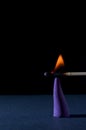 incense is set on fire by a match on a black background Royalty Free Stock Photo