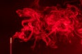 Incense smoke. smoldering piece of wood . incense sticks in blue lighting. aromatic smoke . Red colour Royalty Free Stock Photo