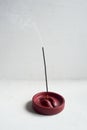 Incense stand red lips. Round shape on a white background. Esotericism, meditation.