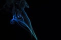 Incense stick with blue smoke against black background Royalty Free Stock Photo