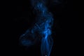 Incense stick with blue smoke against black background Royalty Free Stock Photo