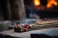 incense stick burning near a row of stones