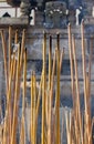 Incense stick burning, smoky and fuming, blur ancient carving sand stone wall on background Royalty Free Stock Photo