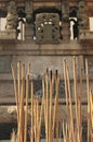 Incense stick burning, smoky and fuming, blur ancient carving sand stone wall on background Royalty Free Stock Photo