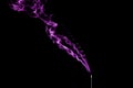 Incense stick with purple smoke on black background Royalty Free Stock Photo