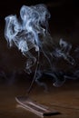 Incense stick smolders and creates smoke and smell Royalty Free Stock Photo