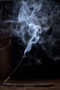 Incense stick smolders and creates smoke and smell Royalty Free Stock Photo