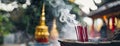 Incense Sticks Emitting Smoke at a Traditional Asian Temple. Incense sticks burn with wisps of smoke rising against a Royalty Free Stock Photo