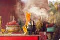 Incense sticks on joss stick pot are burning and smoke use for pay respect to the Buddha, respect to the Buddha in