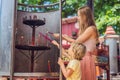 Incense sticks on joss stick pot are burning and smoke use for pay respect to the Buddha, Incense sticks in Mother and