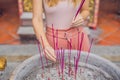 Incense sticks on joss stick pot are burning and smoke use for p