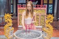 Incense sticks on joss stick pot are burning and smoke use for pay respect to the Buddha, Incense sticks in woman hand