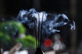 Incense sticks smoldering in holder on blurred background, closeup Royalty Free Stock Photo