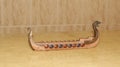 Censer. Censer decorative viking boat made of resin to burn incense, side view and travertine marble base in panoramic view