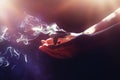 incense in a woman hand, incense smoke on a black background. Royalty Free Stock Photo