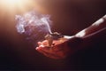 incense in a woman hand, incense smoke on a black background. Royalty Free Stock Photo