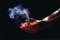incense in a woman hand, incense smoke on a black background. Royalty Free Stock Photo