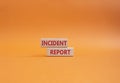 Incident Report symbol. Concept word Incident Report on wooden blocks. Beautiful orange background. Business and Incident Report Royalty Free Stock Photo