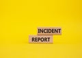 Incident Report symbol. Concept word Incident Report on wooden blocks. Beautiful yellow background. Business and Incident Report Royalty Free Stock Photo