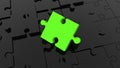 Inclined green puzzle piece on black jigsaw puzzle. Royalty Free Stock Photo