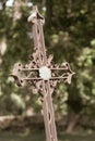 Inclined old curly iron forged cross. Royalty Free Stock Photo