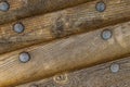 Inclined old wood staves with iron rivets texture snow-covered part of the old ship weather-beaten surface