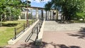 An inclined ramp with metal railings was installed to enter the park for people with disabilities in wheelchairs. Thus, a barrier-