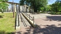 An inclined ramp with metal railings was installed to enter the park for people with disabilities in wheelchairs. Thus, a barrier-