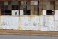 Inclined sidewalk beside broken factory windows Royalty Free Stock Photo