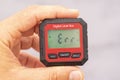 inclinometer, small safe level measuring device between fingers of a hand, error message. Royalty Free Stock Photo