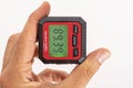 inclinometer, small safe level measuring device between fingers of a hand Royalty Free Stock Photo