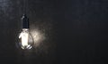 The included electric lamp on the background of the wall Royalty Free Stock Photo