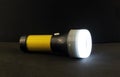 The included flashlight with a yellow handle.