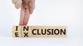 Inclusion or exclusion symbol. Businessman turns wooden cubes and changes words `exclusion` to `inclusion`. Beautiful white Royalty Free Stock Photo