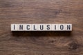 Inclusion - word concept on building blocks, text Royalty Free Stock Photo