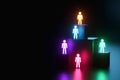 Inclusion, a working group of five multi-colored icons of a human worker on a dark background. team building, cultural diversity,