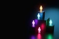 Inclusion, a working group of five multi-colored icons of a human worker on a dark background. team building, cultural diversity,