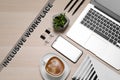 Inclusive workplace. Flat lay composition with smartphone, coffee and laptop on wooden table Royalty Free Stock Photo