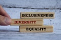Inclusiveness, diversity and equality text on wooden blocks with wooden cover background. Business culture team concept Royalty Free Stock Photo