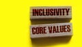 Inclusivity and core values words written on wooden blocks. Social and business concept