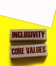 Inclusivity and core values words written on wooden blocks. Social and business concept