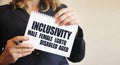 Inclusivity Male Female LGBTQ Disabled Aged words on a card Businesswoman holding big card with a message text written on it. Royalty Free Stock Photo