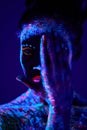incognito black female with fluorescent prints on skin, cosmic paint glowing on neon lights