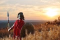 Incognito warrior in iron helmet and red cloak. Royalty Free Stock Photo