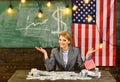 Income planning of budget increase policy. income concept with woman near american flag. Royalty Free Stock Photo