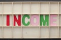 Income Spelled Wooden Letters