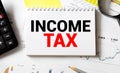 Income and Tax - blue binder on desk in the office Royalty Free Stock Photo