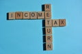 Income Tax Return Crossword on blue Royalty Free Stock Photo